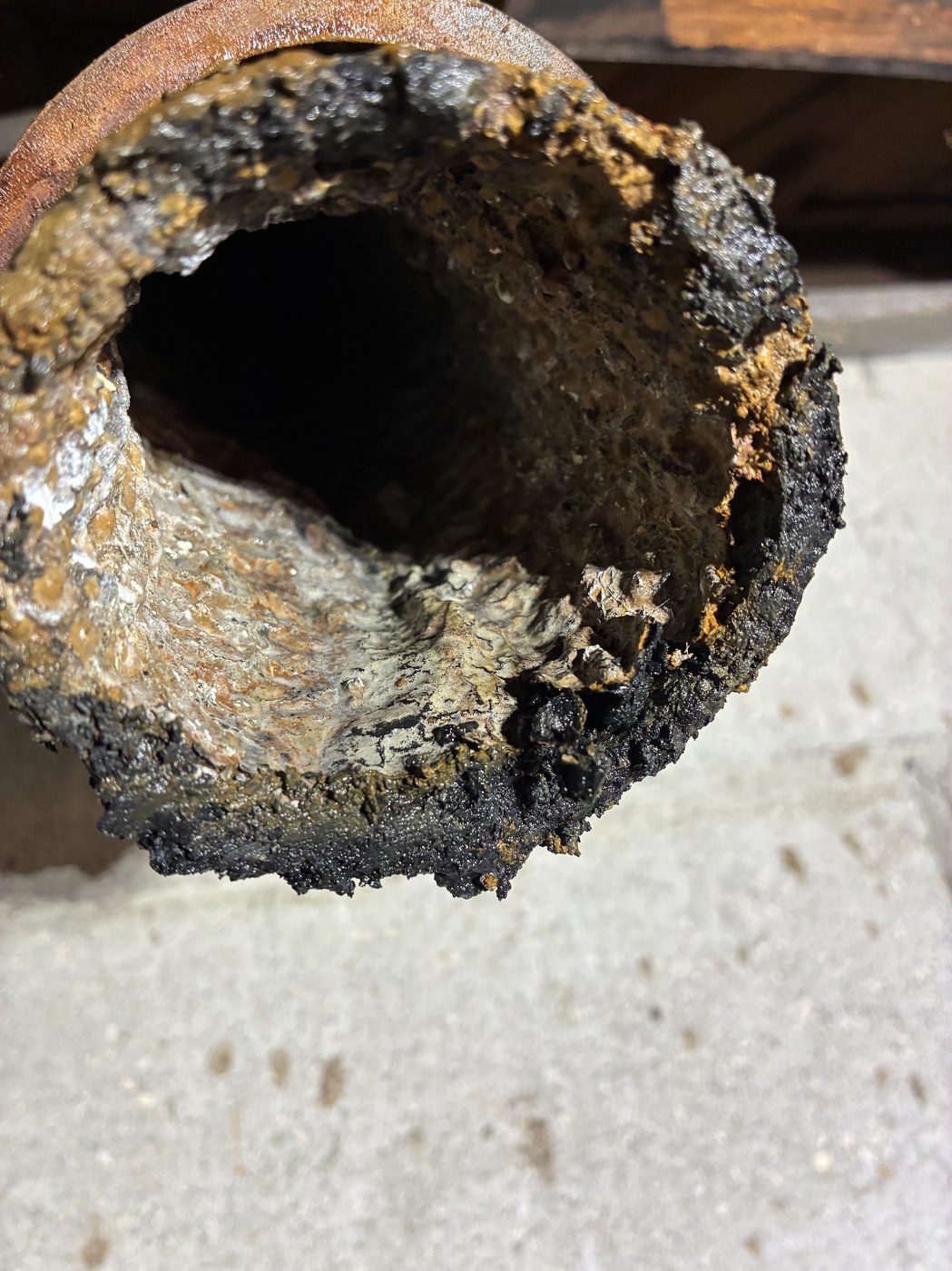 Heavily corroded cast iron sewer pipe interior from a St. Pete, FL home — typical of older Florida plumbing